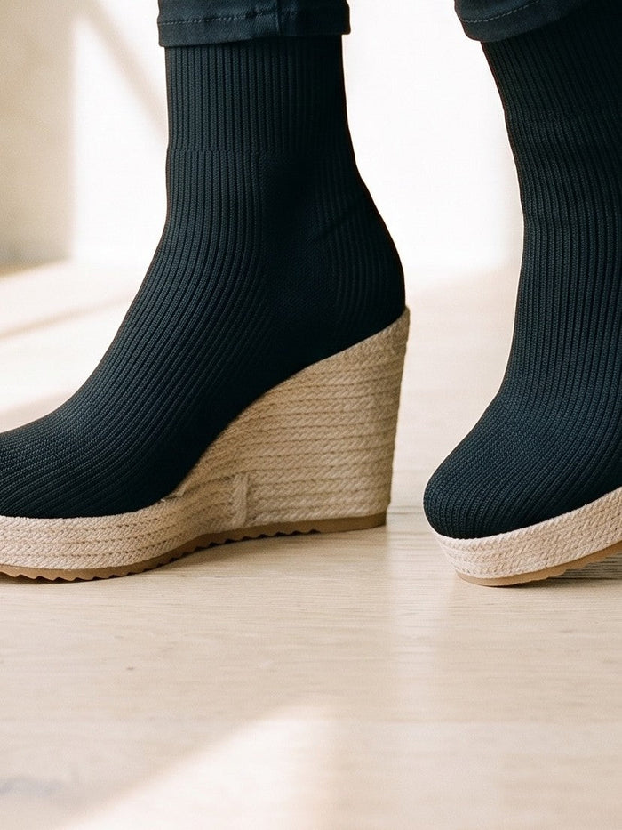 The Rhoda Trainer in Black — the shoe close, worn