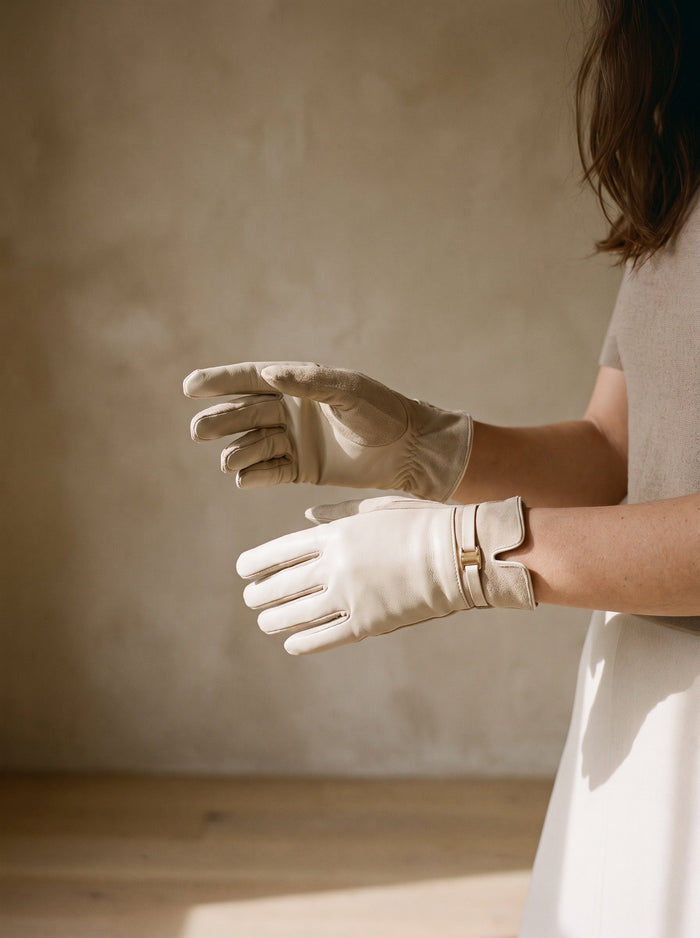 The Faye Glove in Beige, worn on both hands, held at waist height
