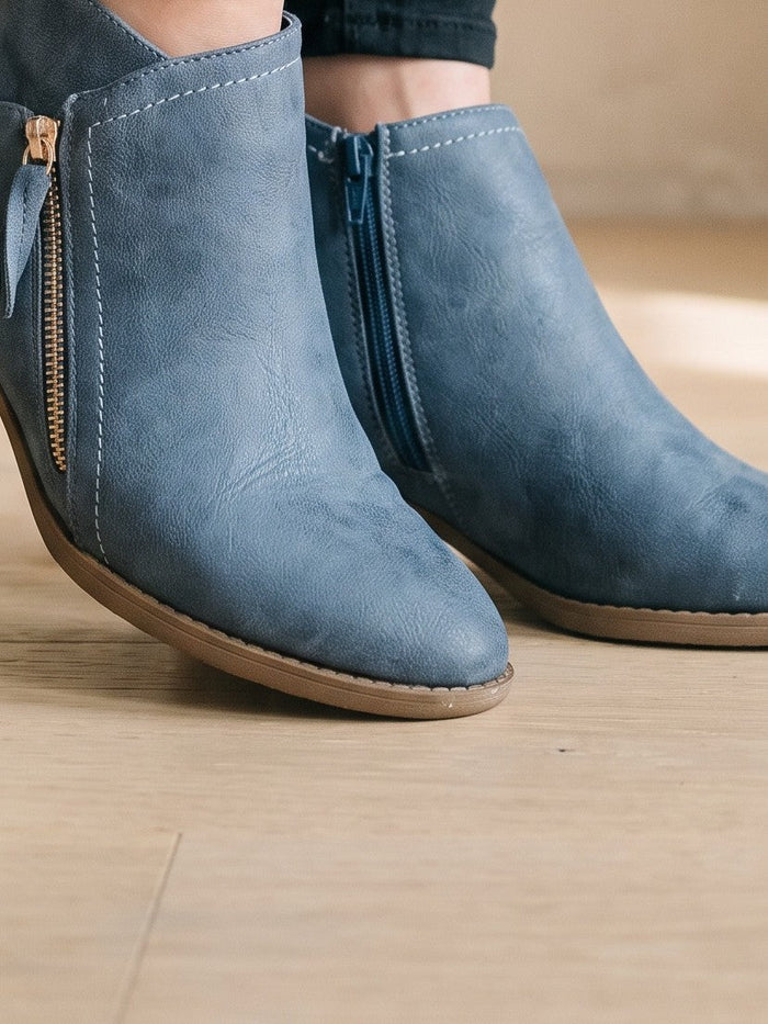 The Beatrix Ankle Boot in Slate Blue — the shoe close, worn