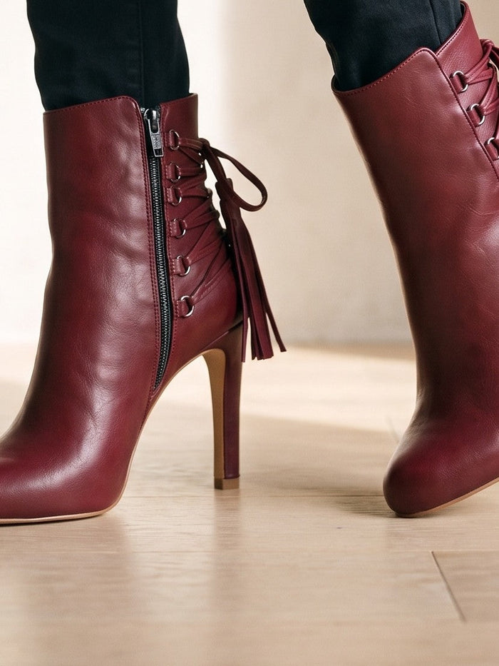 The Vera Ankle Boot in Wine Red — the shoe close, worn