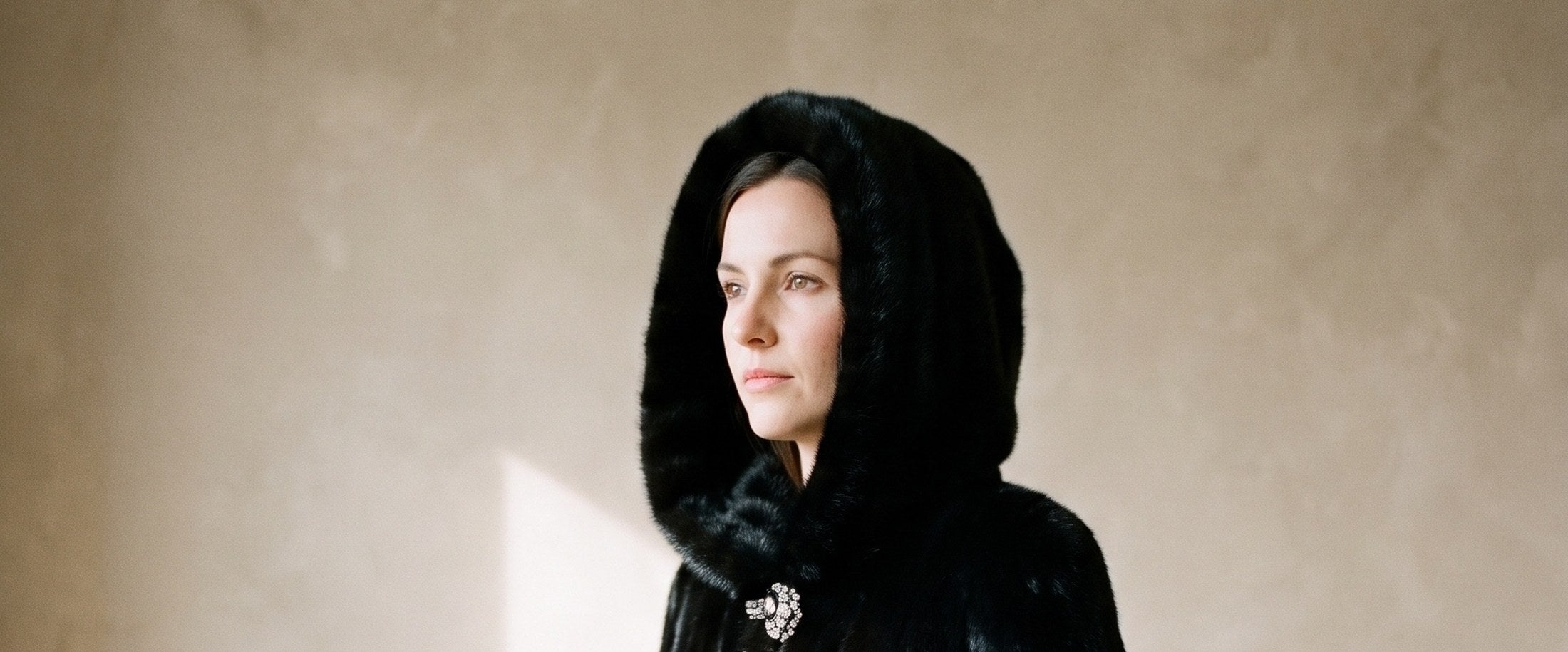 A black hooded coat, worn